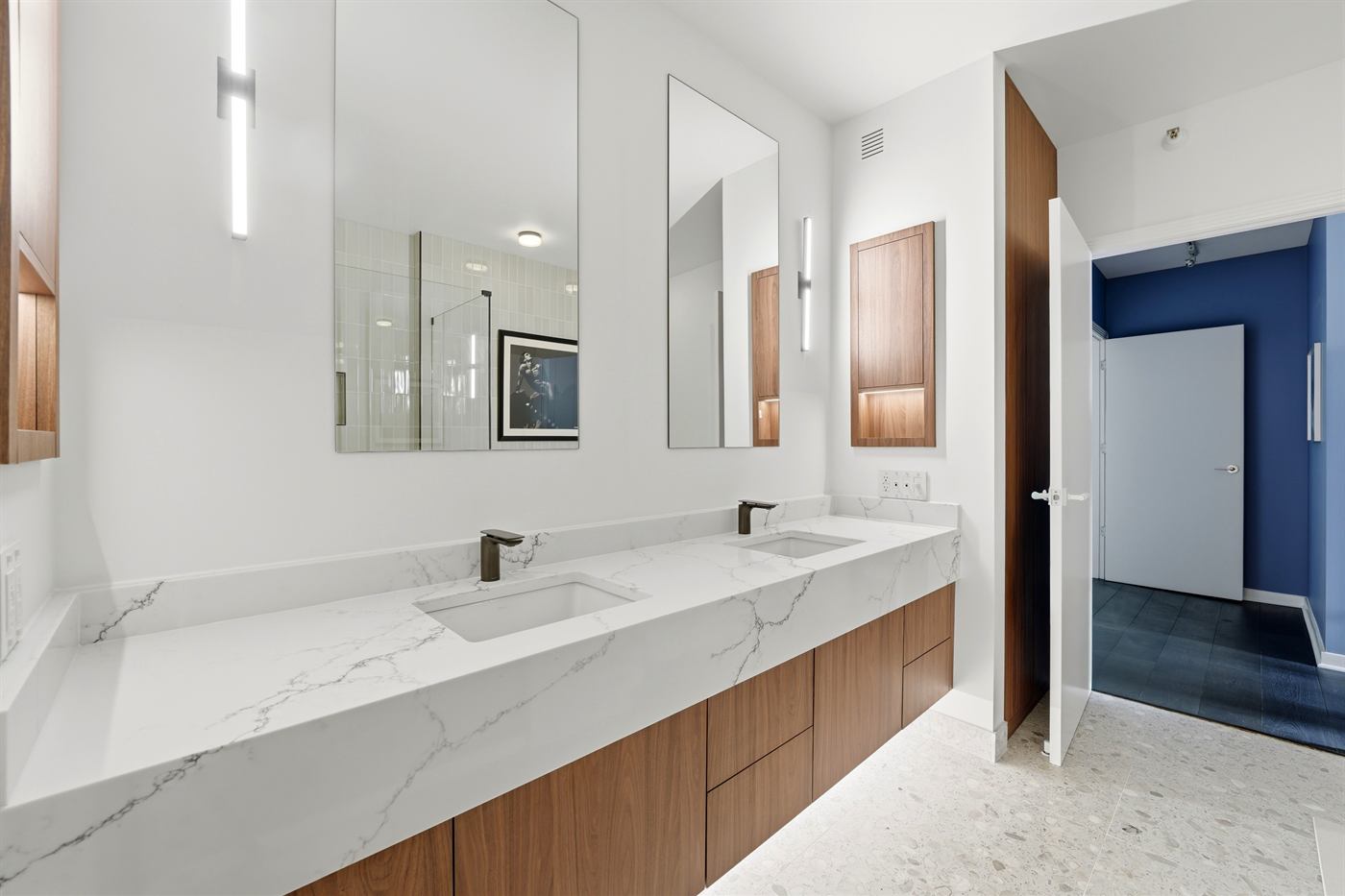 Primary bathroom vanity with integrated sinks, mirrors and linear sconces
