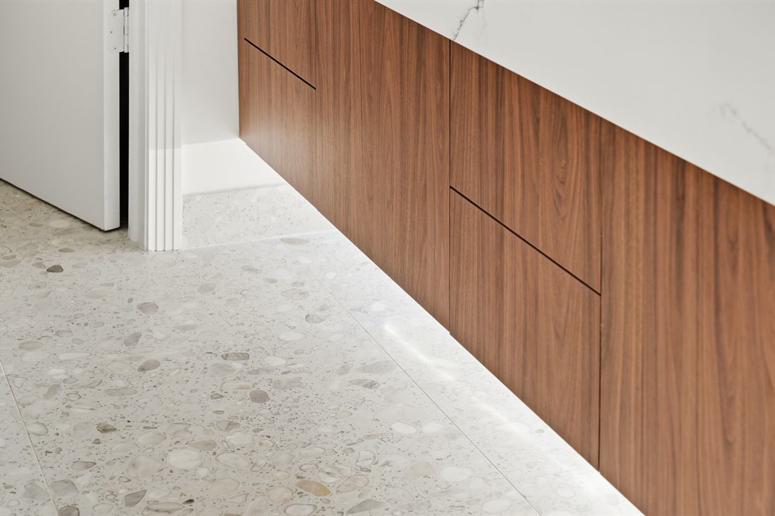 Custom millwork meeting a poured terrazzo floor