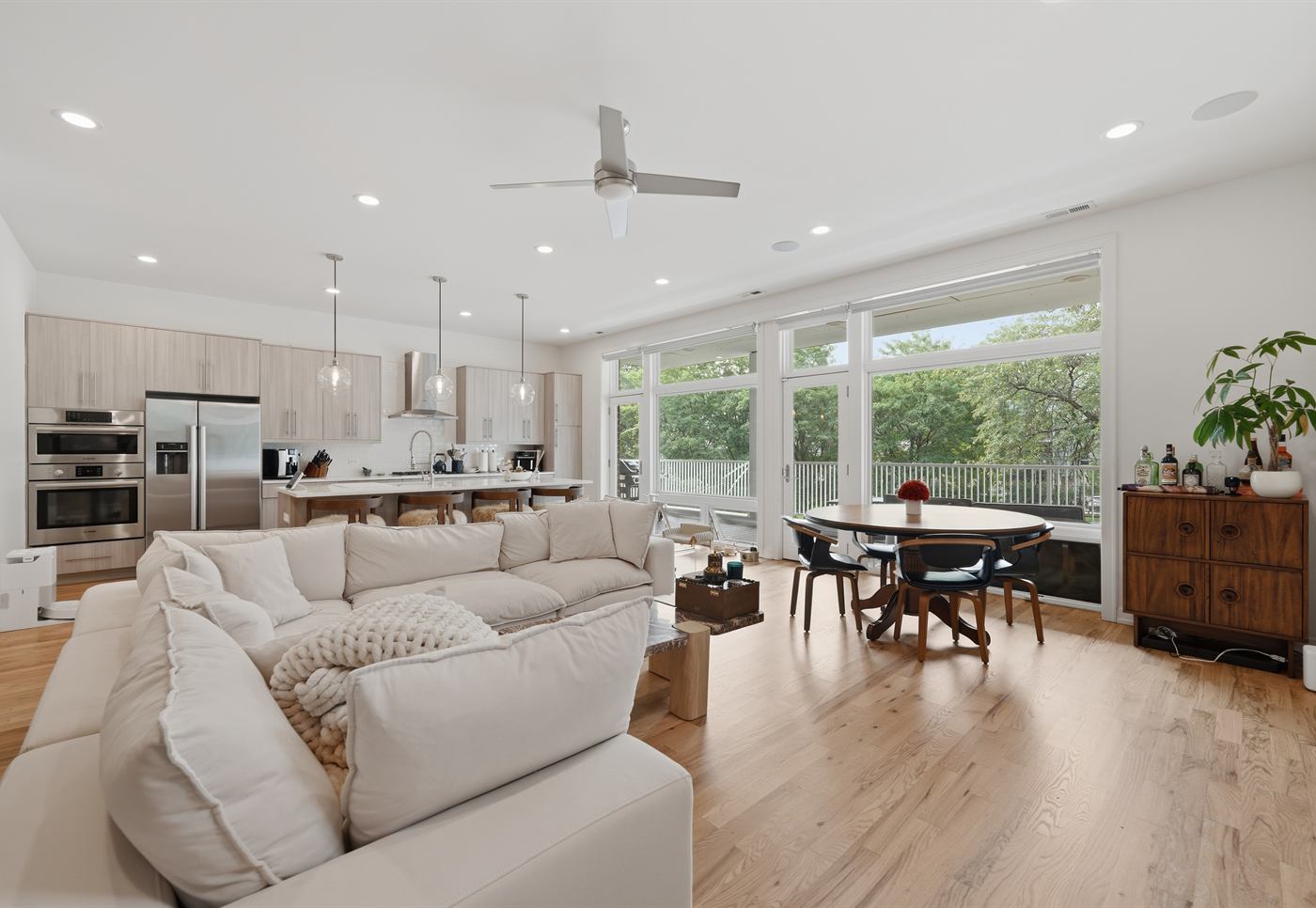 Open-plan living, dining and kitchen with white oak floors at 1832 W Rice Street