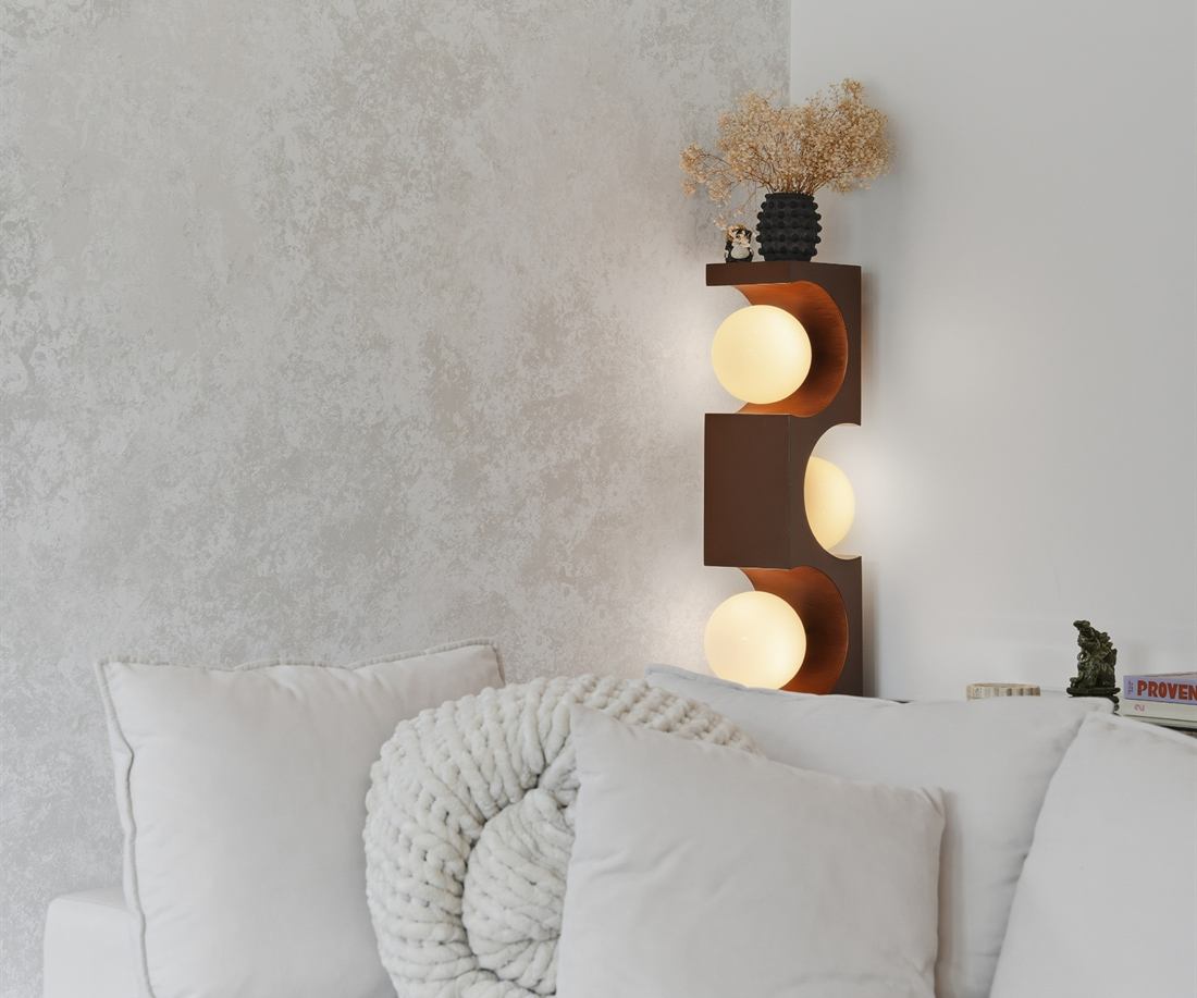 Venetian plaster accent wall with a sculptural wall sconce