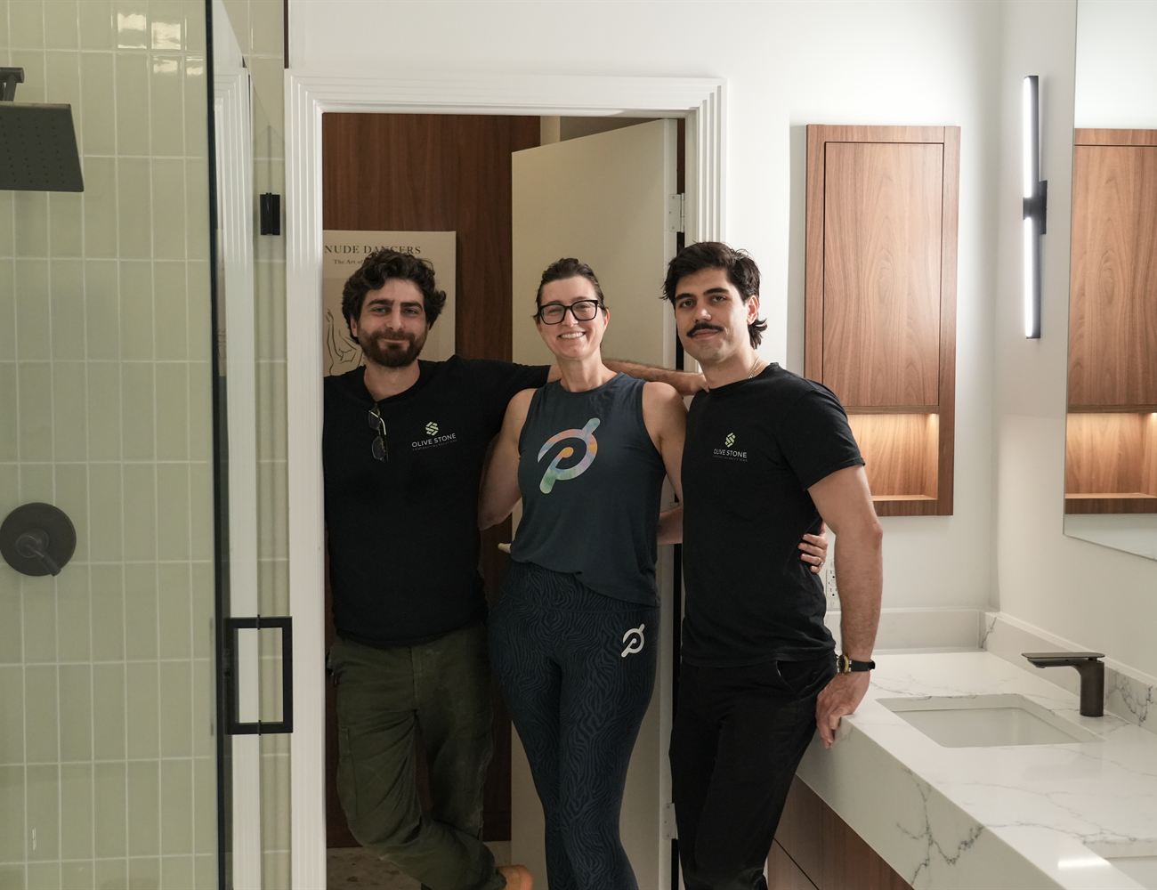 Three members of the Olive Stone team standing in a completed bathroom