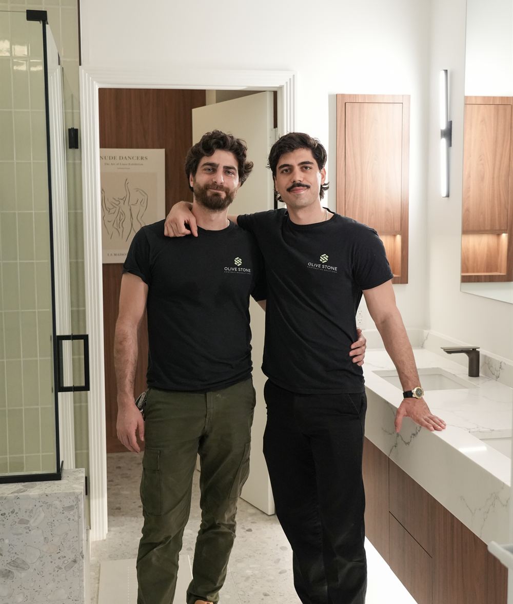 Two Olive Stone team members in a finished primary bathroom